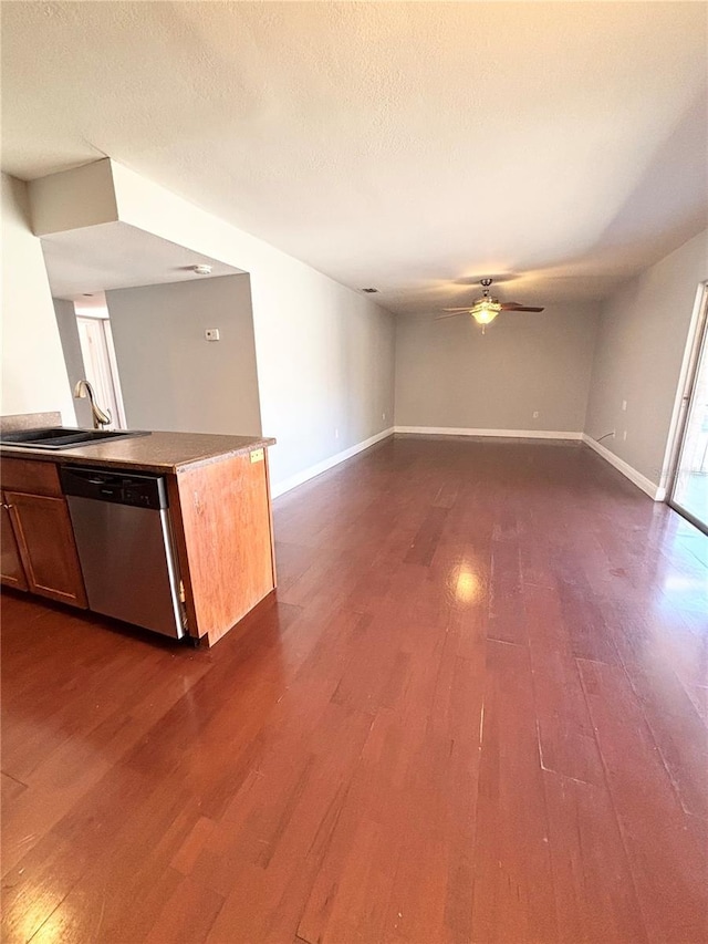 kitchen with dark hardwood / wood-style flooring, ceiling fan, sink, and stainless steel dishwasher