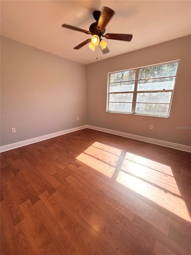 empty room with hardwood / wood-style floors and ceiling fan