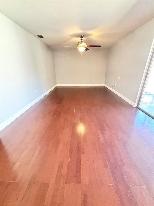 spare room with ceiling fan and wood-type flooring