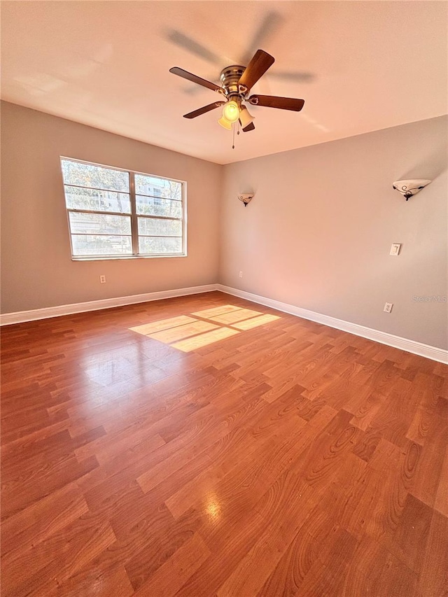 spare room featuring ceiling fan and light hardwood / wood-style floors