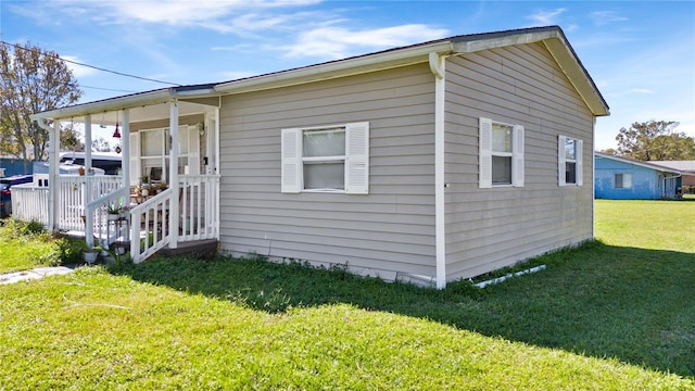 710 Spruce St, New Smyrna Beach, FL 32168 - view of home's exterior featuring a lawn