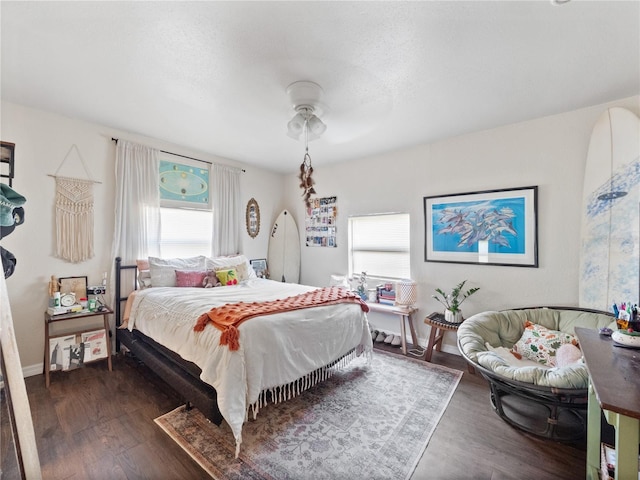 710 Spruce St, New Smyrna Beach, FL 32168 - bedroom with dark wood-style flooring, baseboards, and a ceiling fan