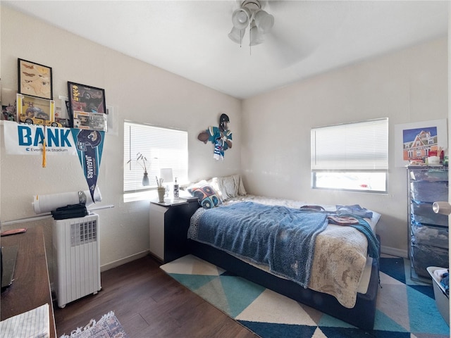 710 Spruce St, New Smyrna Beach, FL 32168 - bedroom with radiator, wood finished floors, ceiling fan, and baseboards