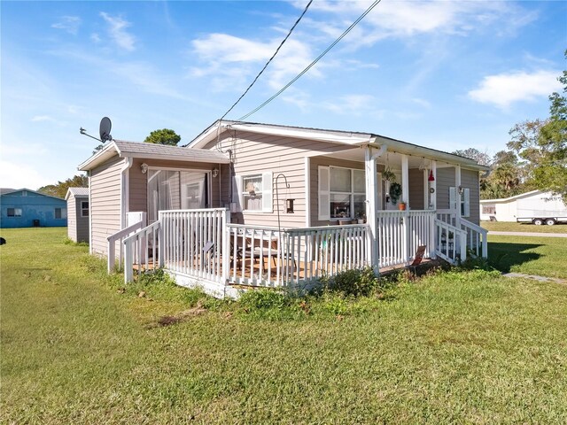 710 Spruce St, New Smyrna Beach, FL 32168 - view of front facade featuring a front lawn and a porch