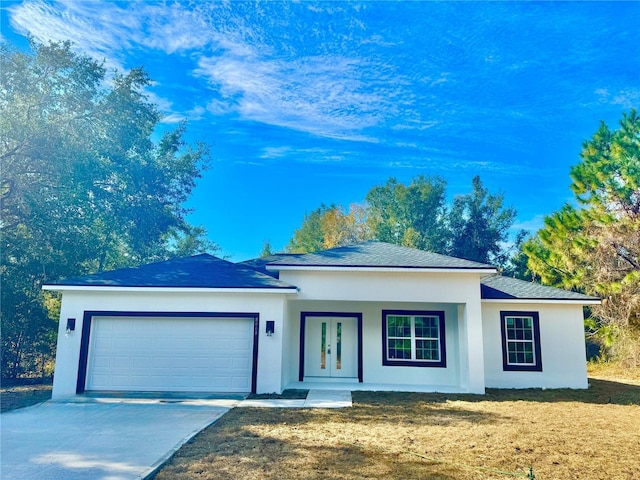 view of front facade with a porch, a garage, and a front lawn