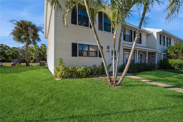 view of front of home featuring cooling unit and a front lawn