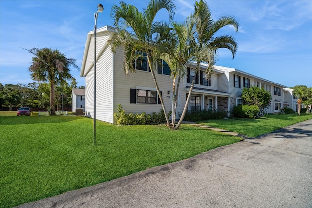 view of front of property featuring central AC unit and a front lawn