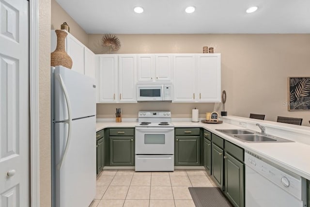 kitchen with white appliances, sink, light tile patterned floors, white cabinets, and green cabinets