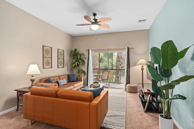 carpeted living room with ceiling fan