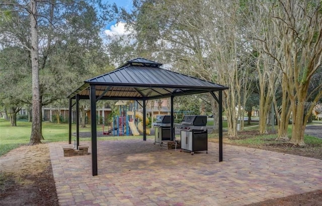 view of patio / terrace featuring a gazebo, a grill, and a playground