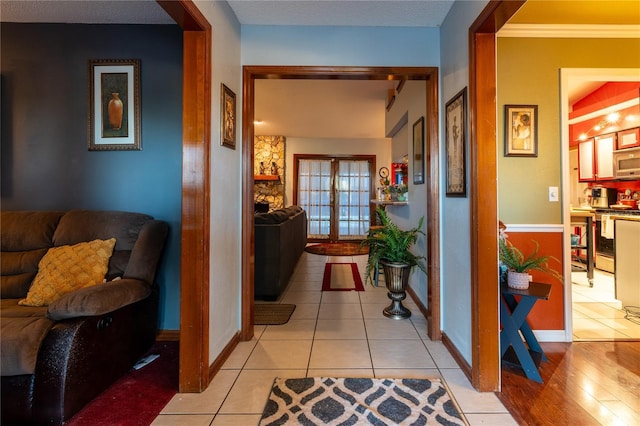 hallway featuring crown molding and light hardwood / wood-style floors