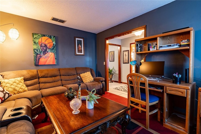 tiled living room featuring a textured ceiling