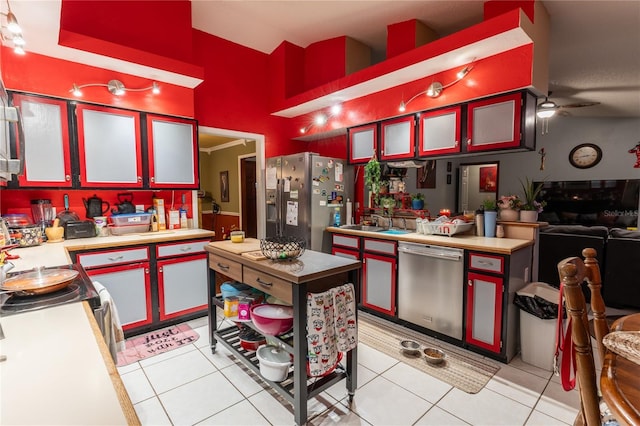 kitchen with light tile patterned floors, stainless steel appliances, ceiling fan, and sink