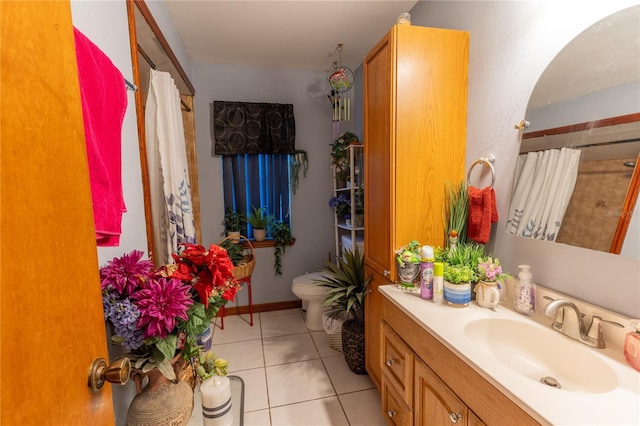 bathroom featuring tile patterned floors, vanity, and toilet