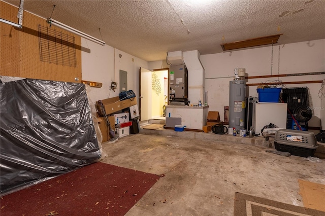 garage featuring heating unit, electric panel, and water heater