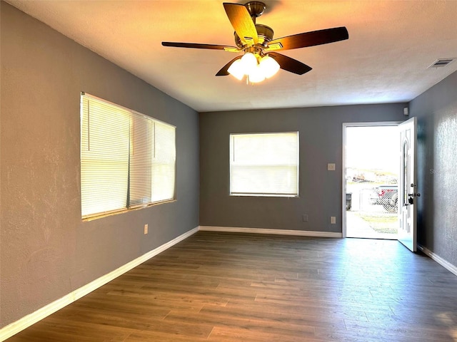 spare room with ceiling fan and dark hardwood / wood-style flooring