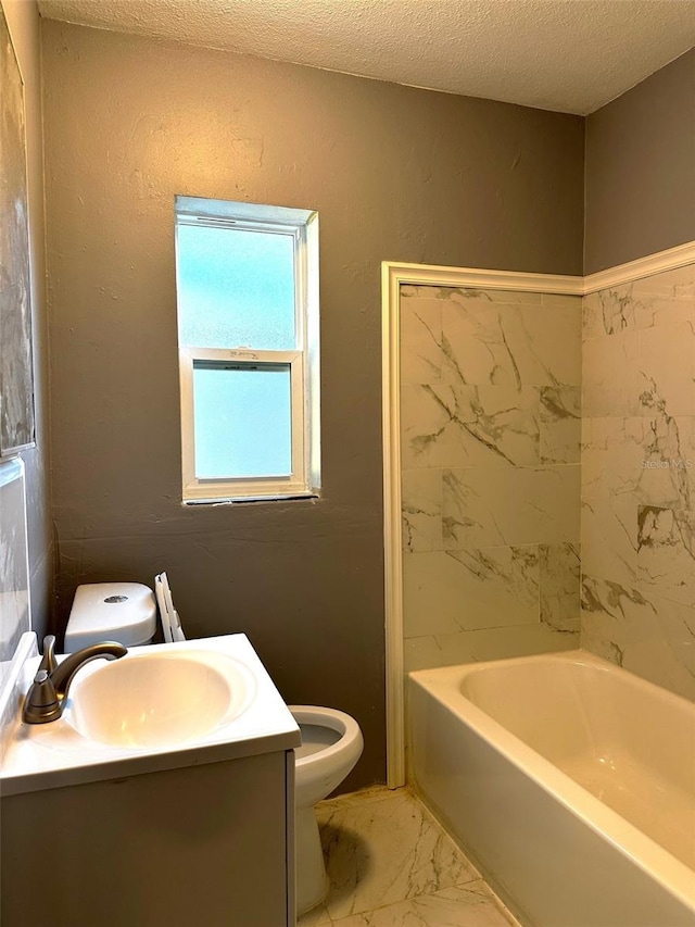 bathroom with vanity, a textured ceiling, and toilet