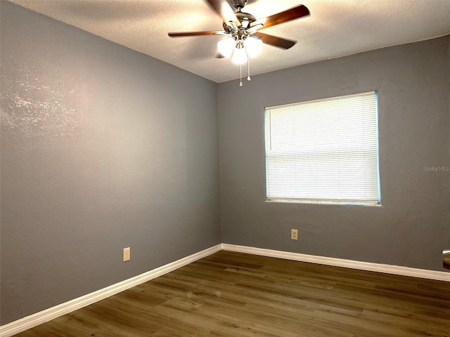 empty room featuring hardwood / wood-style flooring, ceiling fan, and a textured ceiling