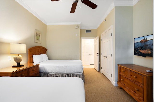 carpeted bedroom with ceiling fan and ornamental molding