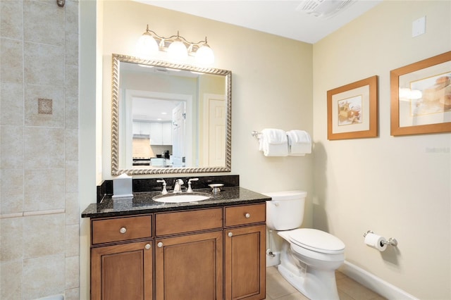 bathroom featuring tile patterned flooring, vanity, and toilet