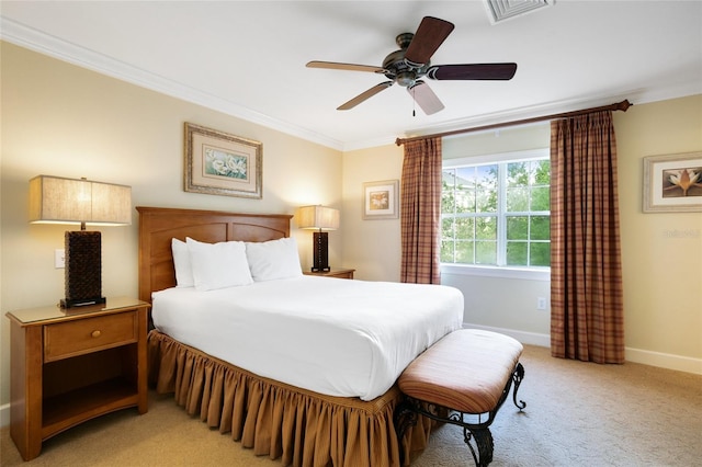 bedroom featuring ceiling fan, crown molding, and light carpet