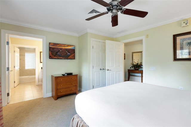 bedroom featuring ornamental molding, light colored carpet, ceiling fan, connected bathroom, and a closet