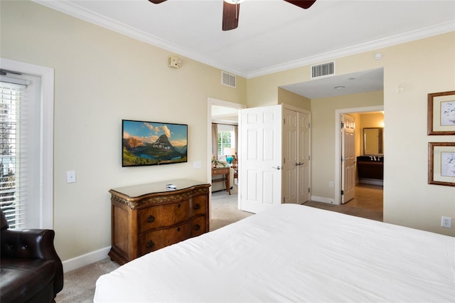 bedroom featuring connected bathroom, light colored carpet, ceiling fan, and crown molding