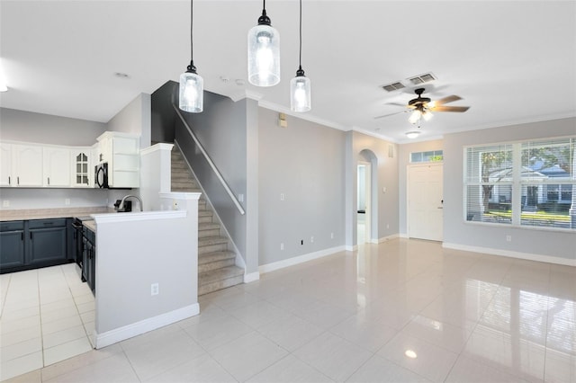 kitchen featuring ornamental molding, ceiling fan, decorative light fixtures, white cabinets, and light tile patterned flooring