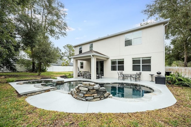 back of house featuring a pool with hot tub and a patio area