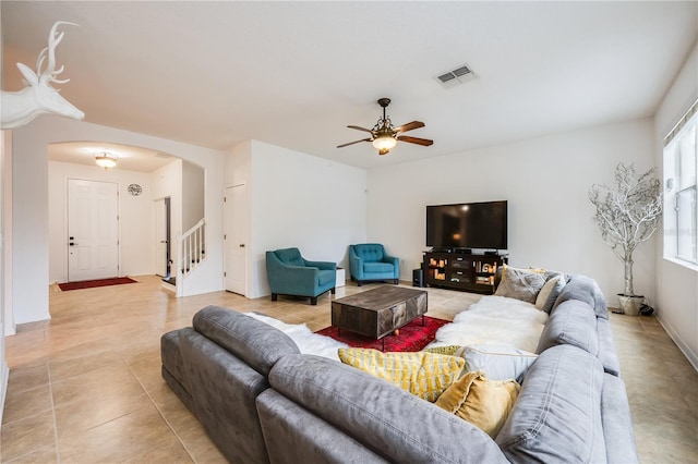 tiled living room with ceiling fan