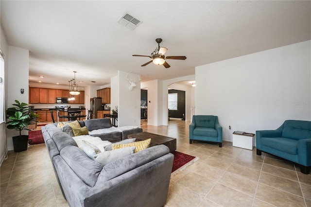 tiled living room featuring ceiling fan