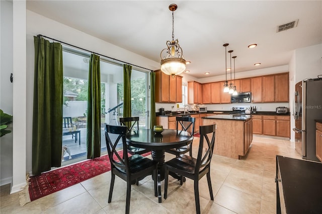 tiled dining room featuring sink