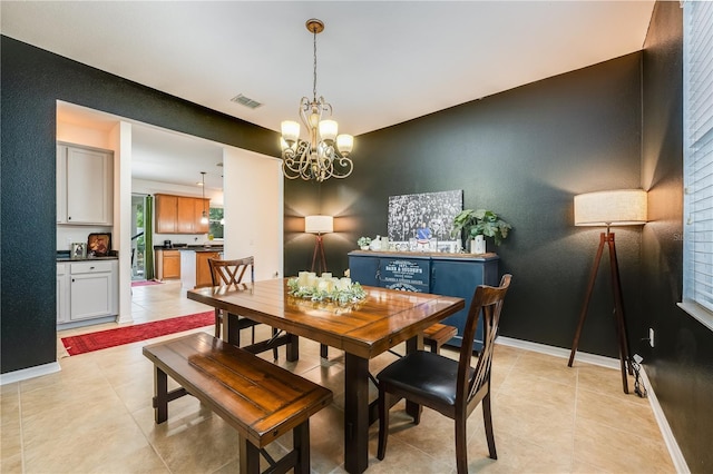 dining area featuring light tile patterned floors and a notable chandelier