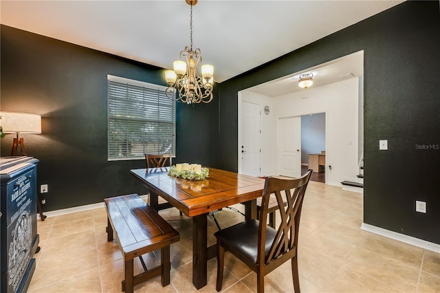 tiled dining space featuring a chandelier