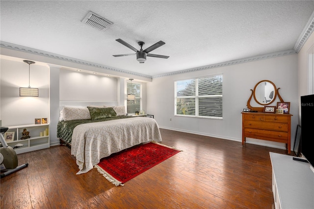 bedroom with ceiling fan, dark hardwood / wood-style flooring, and a textured ceiling