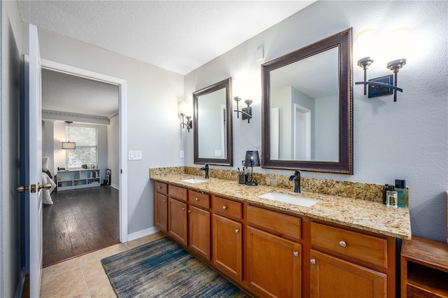 bathroom with vanity, tile patterned flooring, and a textured ceiling