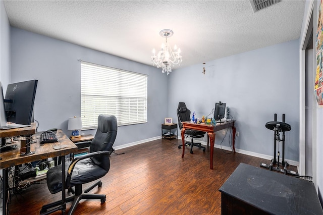 office area featuring a textured ceiling, a notable chandelier, and dark hardwood / wood-style flooring