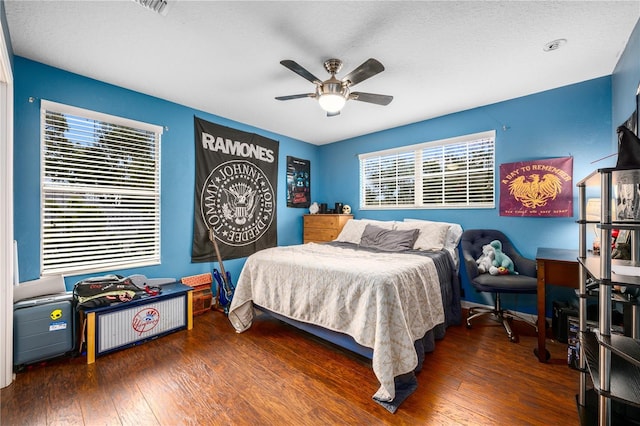 bedroom featuring ceiling fan and dark hardwood / wood-style floors