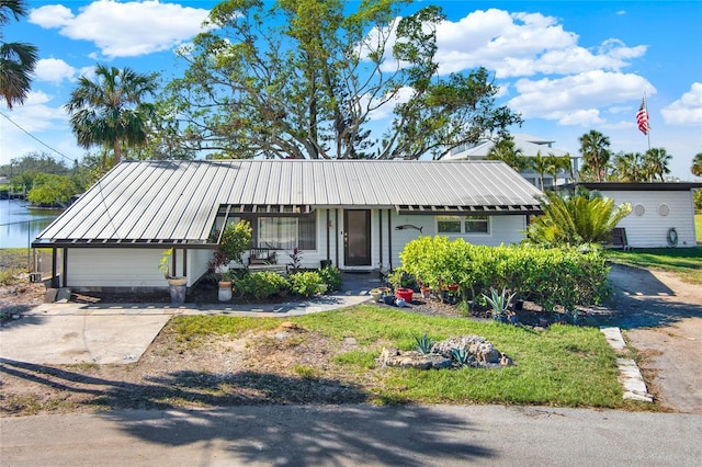 view of front of home with a porch and a water view