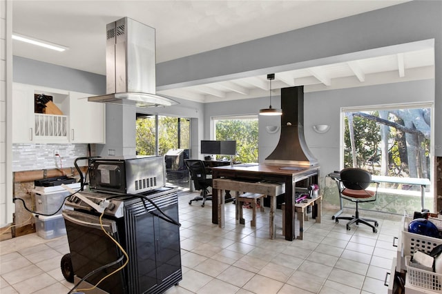 tiled dining room with beamed ceiling and plenty of natural light