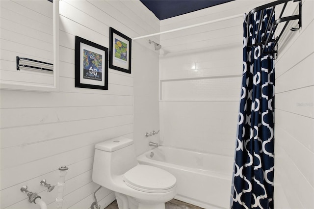 bathroom featuring wooden walls, shower / bath combination with curtain, and toilet