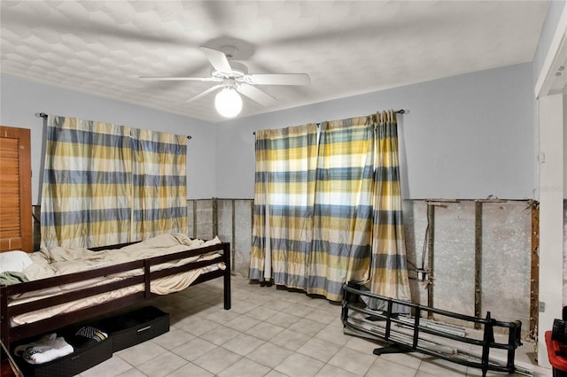 tiled bedroom with ceiling fan