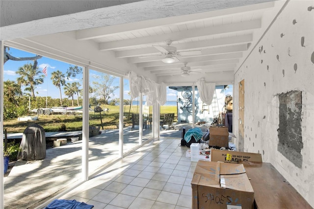 sunroom featuring beamed ceiling and ceiling fan