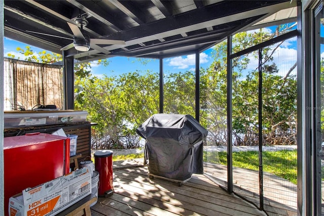 wooden deck with ceiling fan and area for grilling