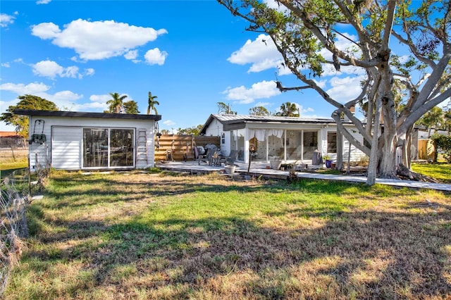 rear view of house with a patio and a lawn