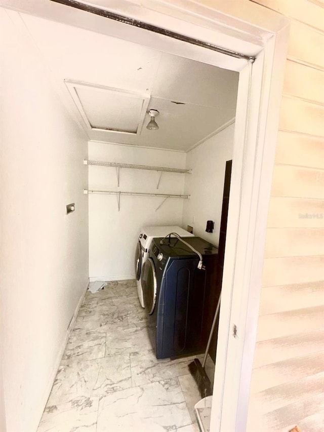 washroom with separate washer and dryer and wooden walls