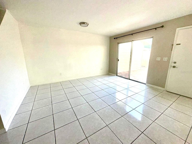 spare room featuring light tile patterned floors and a textured ceiling