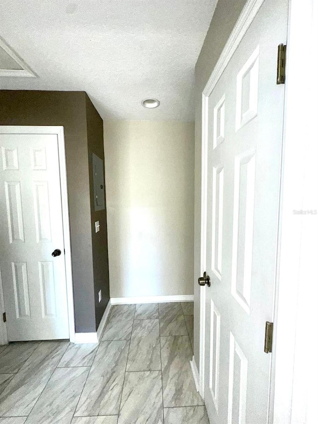 hallway featuring a textured ceiling