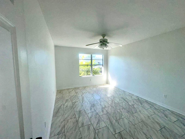 unfurnished room with a textured ceiling and ceiling fan