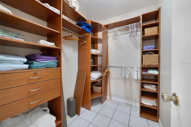 walk in closet with light tile patterned flooring